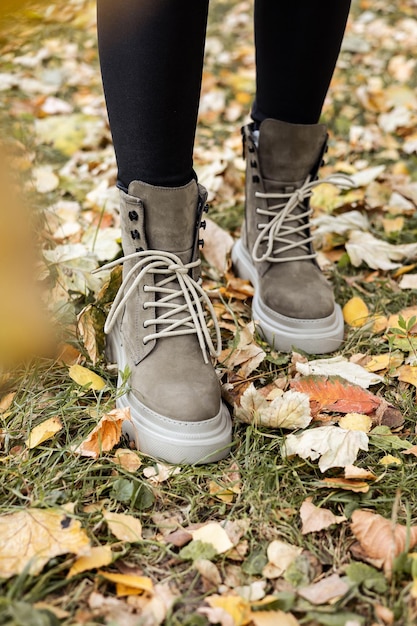 New collection of women's spring shoes. Slender female legs close-up in genuine leather boots.