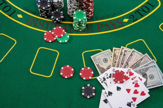 New dollars playing cards colored chips scattered on the playing green poker table Poker concept