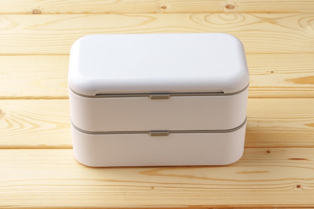 New empty plastic lunch box on a wooden background