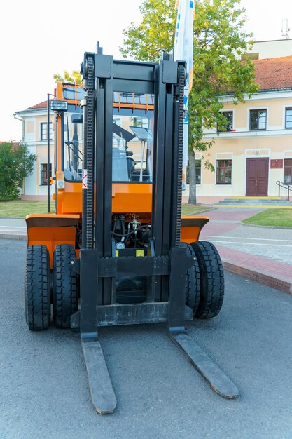 A new forklift truck stands on the street at an exhibition of new equipment Front projection on the loader