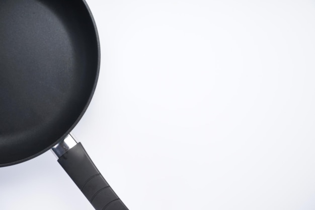 New frying pan on white background top view Space for text