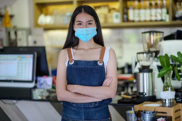 New generation women wearing a face mask do small business in coffee shop counter