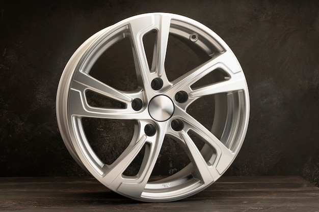 New grey alloy wheels on a dark textured black background a wheel for a car