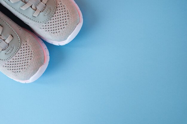 New grey sneakers on pastel blue background