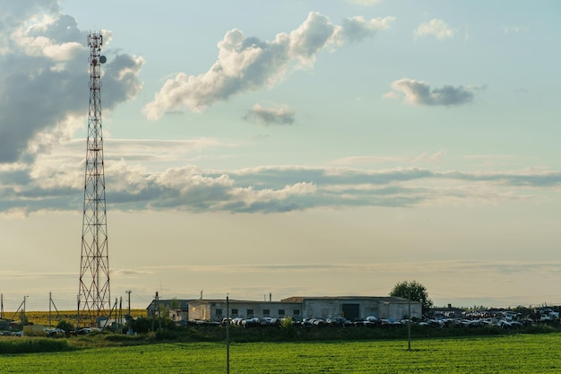 New GSM antennas on a high tower against a blue sky background 5G signal transmissions are dangerous to health Radiation pollution of the environment through cell towers Harm to health