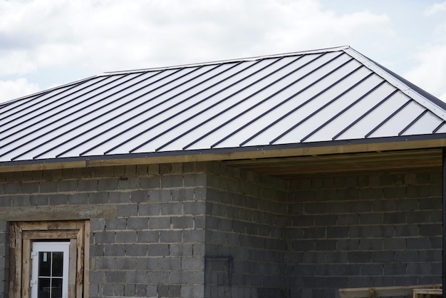 A new house the roof of which is made of metal Cottage in the countryside roof made of modern materials