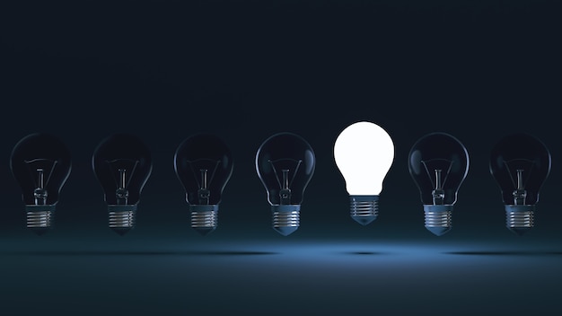 New Idea concept and light bulb that illuminate on blue background