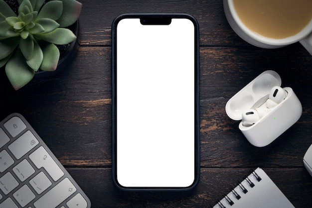 The new iPhone 14 pro max with an empty white screen copy space mockup an office space on the desktop and a coffee mug Krasnoyarsk Russia 2022 10 01