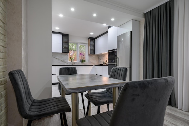 New large modern well designed white kitchen and dining room in studio flat interior