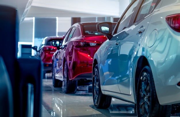 new luxury red and white cars parked in modern showroom