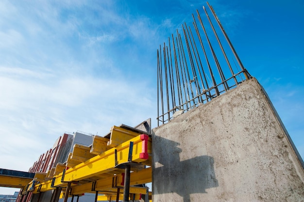 a new monolithic house under construction against the blue sky