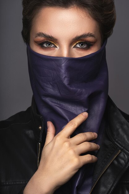 New normal fashion after virus pandemic. Portrait of stylish woman wearing leather neck gaiter instead of prevention mask.