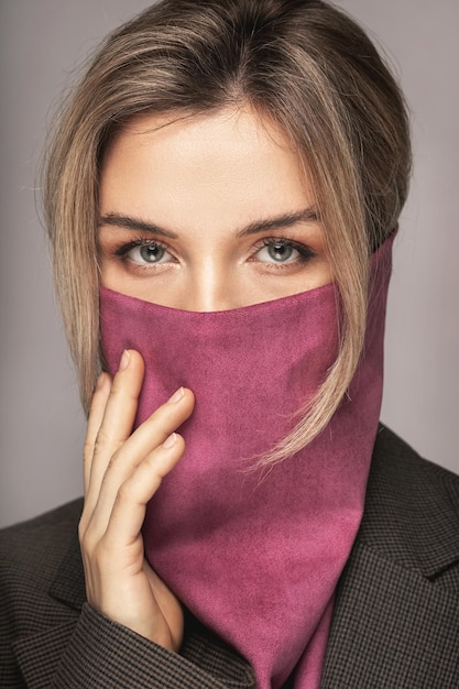 New normal fashion. Beautiful woman wearing stylish leather bandana instead of prevention mask.