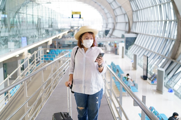 New Normal tourist wearing face mask is traveling on The airport  New lifestyle travel after covid19