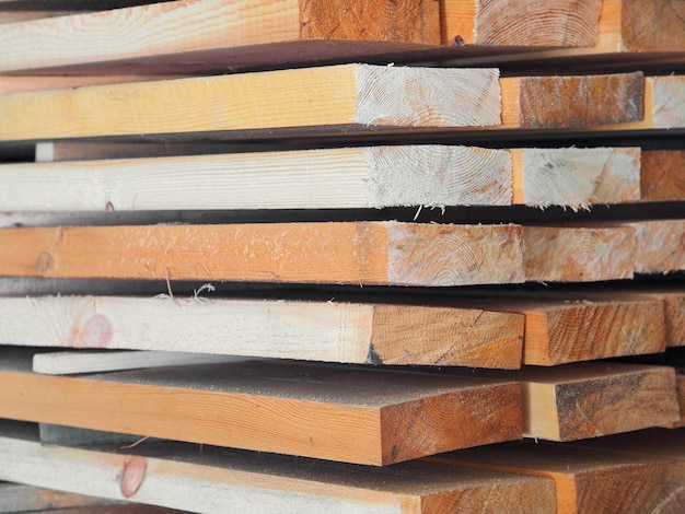 New planed wooden boards stacked in sawmill Procurement and sale of building material Dry wood Woodworking Background