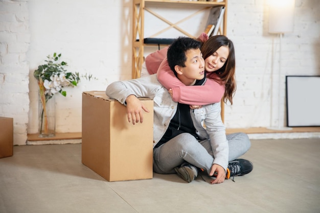 New property owners, young couple moving to new home, apartment, look happy