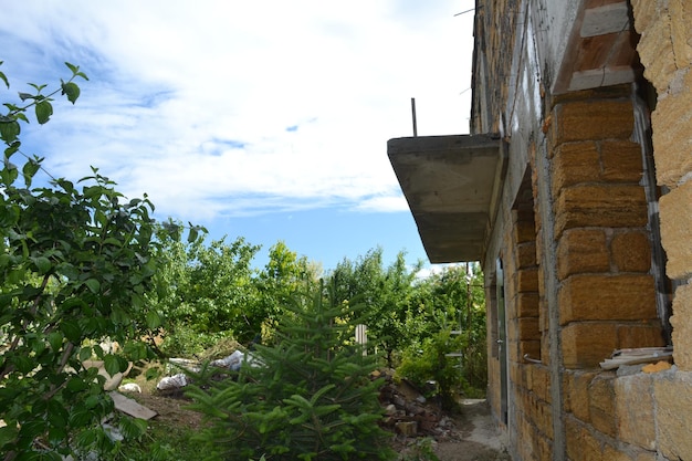 A new twostory stone house among a young green garden Country life