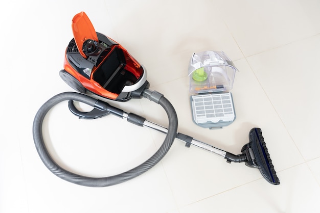 New vacuum cleaner and cleaner brush heads on white tile floor