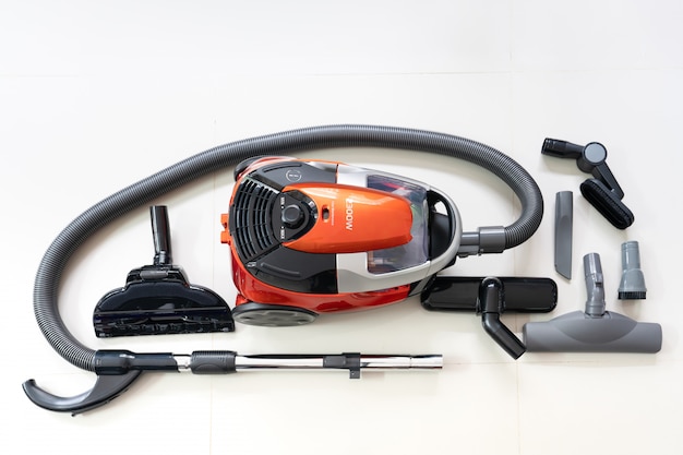 New vacuum cleaner and cleaner brush heads on white tile floor