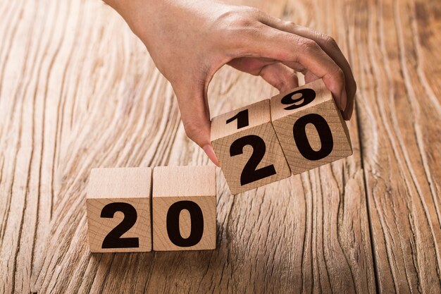 Photo new year 2019 change to 2020 hand change wooden cubes.