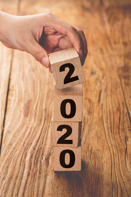 Photo new year 2019 change to 2020 hand change wooden cubes.