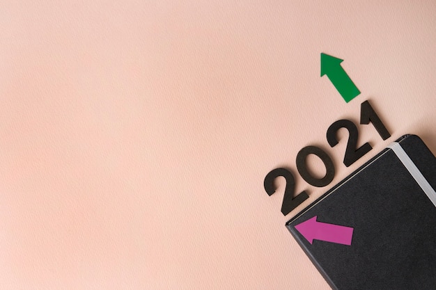 New Year 2021 diary on pink surface