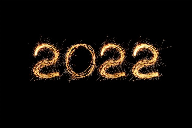 New Year 2022 light. Sparklers draw figures 2022. Bengal lights and letter