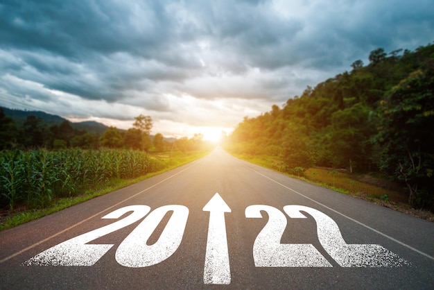 New year 2022 or straight forward concept Text 2022 written on the road in the middle of asphalt road with at sunset Concept of planning goal challenge new year resolution