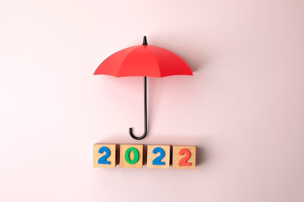 New Year 2022 with red umbrella on pink background