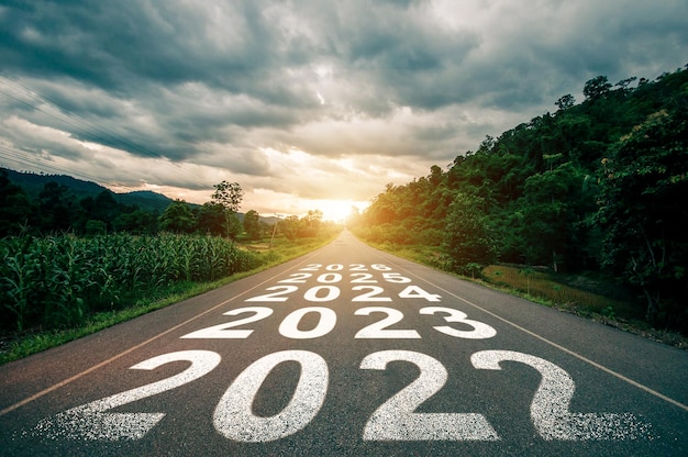 New year 2023 2024 2025 2026 or straight forward concept Text 2023 written on the road in the middle of asphalt road with at sunset Concept of planning goal challenge new year resolutionxA