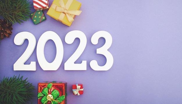 New Year 2023 background with Christmas balls and fir branches Abstract christmas lights on background