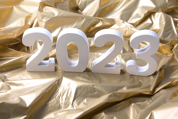 New Year 2023 Figures on a golden background