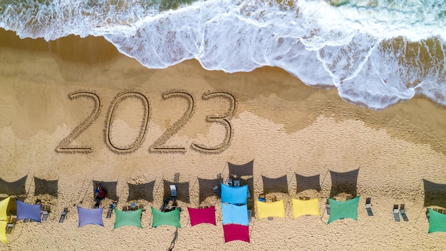 New year 2023 handwritten in the sand surface. Brazil, Ubatuba, Sao Paulo