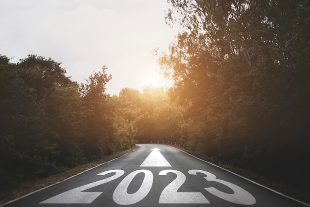 New year 2023 or straight forward concept Text 2023 written on the road in the middle of asphalt road with at sunset Concept of planning goal challenge new year resolution