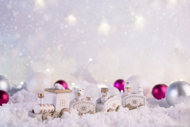 New Year card with toy train with snow and lights