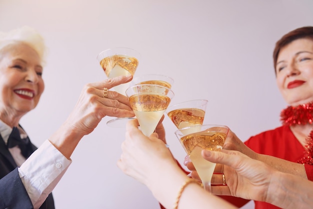 new year celebrating hands with glasses of white sparkling wine