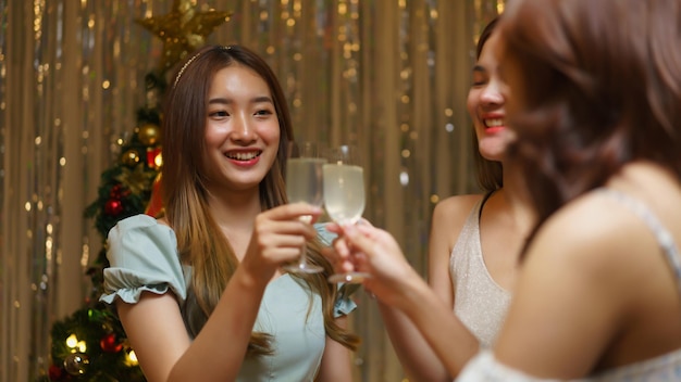 New Year celebration concept Young beautiful group clinking champagne and having fun in party