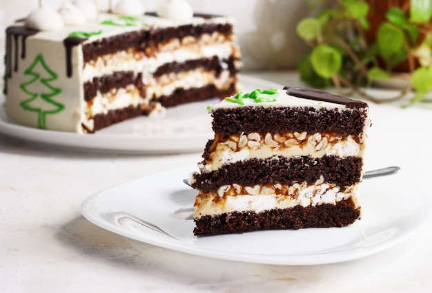 New Year chocolate cake, a slice on a plate on a light