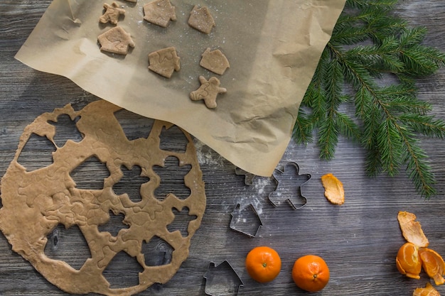 New Year and Christmas decorations on a wooden surface with tangerines and a Christmas tree Prepare sweets for the celebration of Christmas