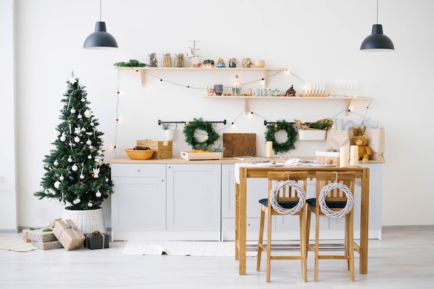 New year and Christmas. Festive Scandinavian cuisine in Christmas decorations. Candles, fir branches, wooden stands, table.