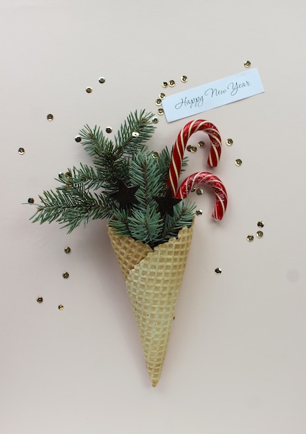 New Year Christmas  holiday party celebration waffle cone candy canes fir tree branch copy space