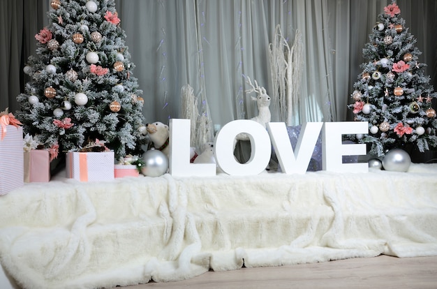 New year cozy interior with a large plush veil, two Christmas trees