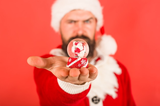 New year decoration santa with christmas snowglobe christmas snowglobe in hand christmas toy in hand