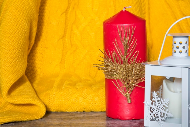 New year decorations and decorations with a yellow sweater and a red candle