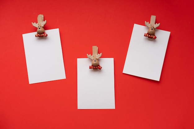 new year empty greeting cards mockups on a clothespin on a red space for text new year