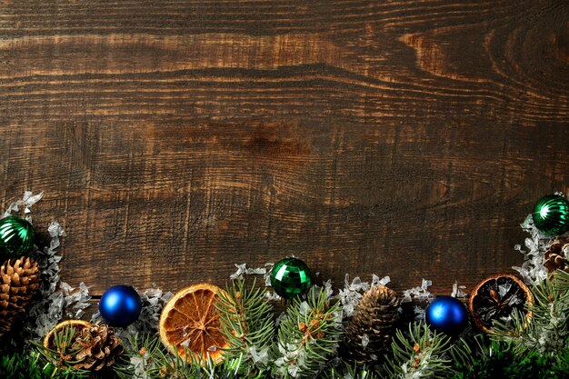 New Year frame  with a Christmas tree and colored Christmas decorations on a brown background