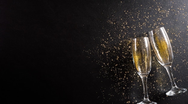 New Year holidays background concept made from champagne glasses with golden glitter