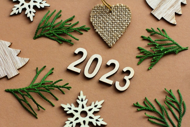 The new year is coming wooden numbers 2023 Christmas decorations made of ecofriendly materials toys made of wood paper cardboard