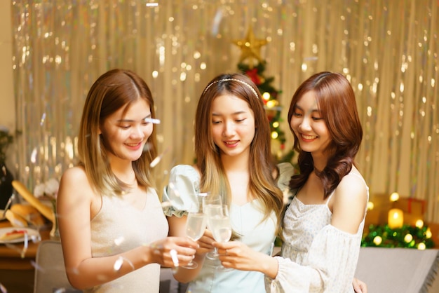 New Year party concept Young beautiful group clinking champagne to celebrating with fun in party