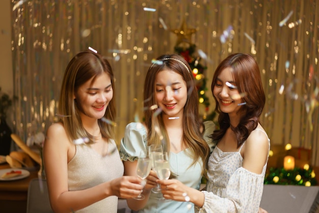 New Year party concept Young beautiful group clinking champagne to celebrating with fun in party